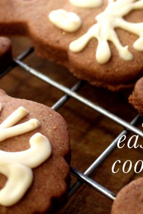 Homemade bunny face dog Easter biscuits with white icing whiskers cooling on a wire rack.