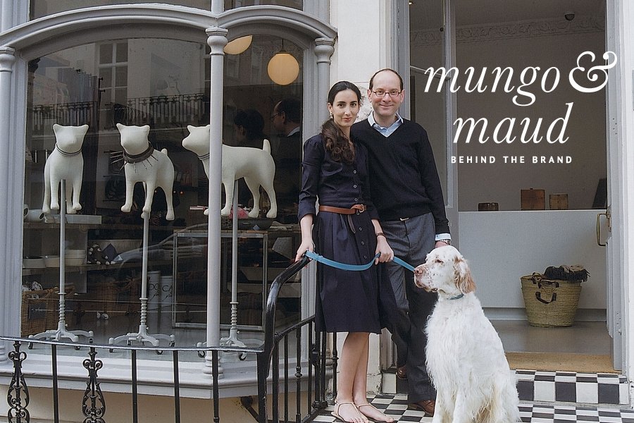 Mungo & Maud founders standing with their dog outside their luxury pet boutique for a behind the brand feature.