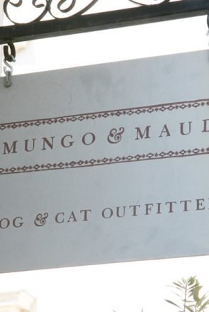 Mungo & Maud Dog & Cat Outfitters hanging metal storefront sign.