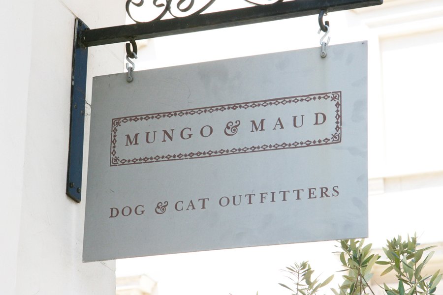 Mungo & Maud Dog & Cat Outfitters hanging metal storefront sign.