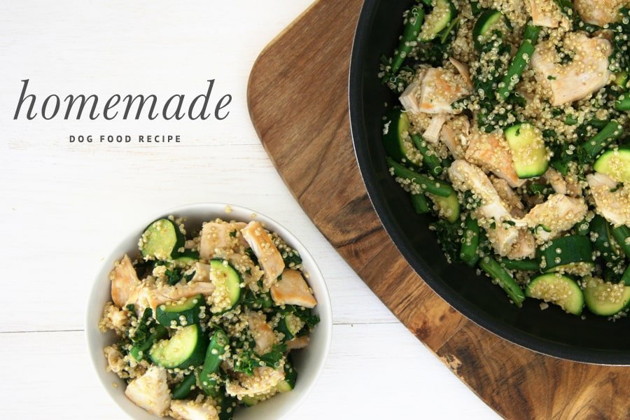 Healthy homemade chicken and kale stir fry dog food recipe with quinoa and zucchini in a white bowl and skillet.