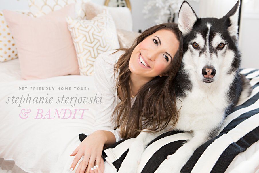 Stephanie Sterjovski and her Husky dog Bandit posing on a bed for a pet friendly home tour.