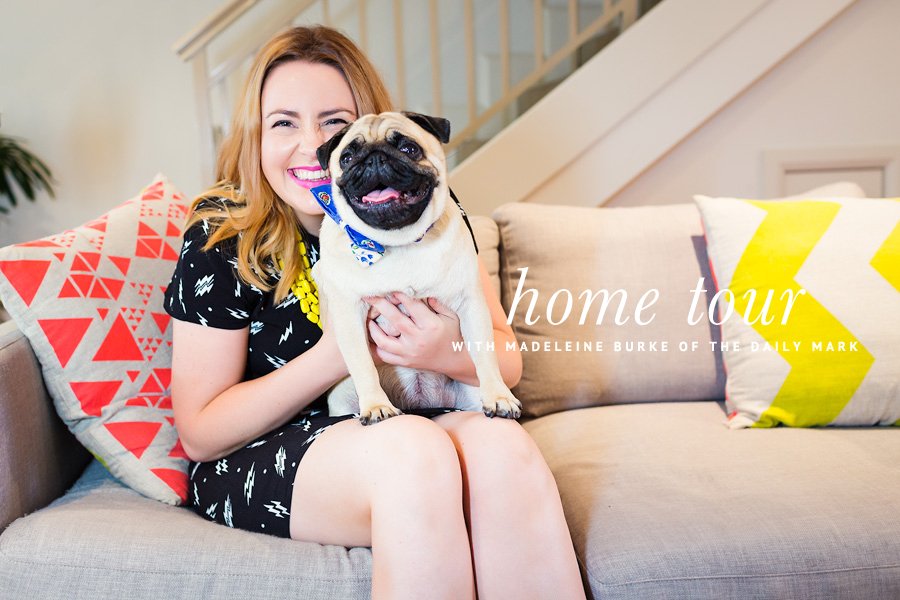 Madeleine Burke of The Daily Mark sits on a couch with her pug, Wilma, during their pet-friendly home tour.