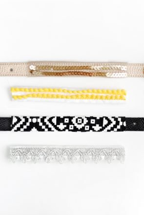 Two stylish dog collars in gold sequin and black geometric patterns, featuring elegant gold buckles.