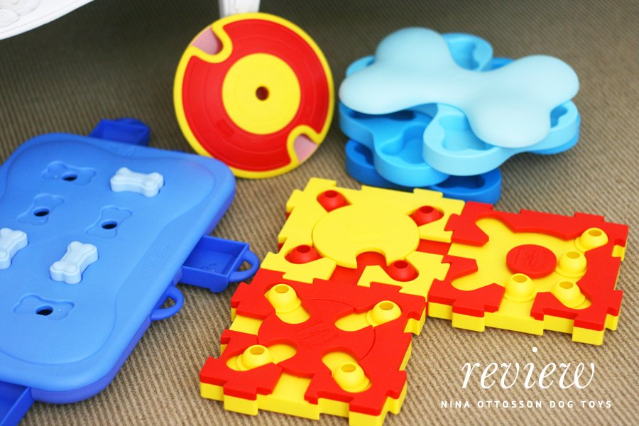 Assorted Nina Ottosson dog puzzle toys and interactive treat games in bright colors for mental stimulation.