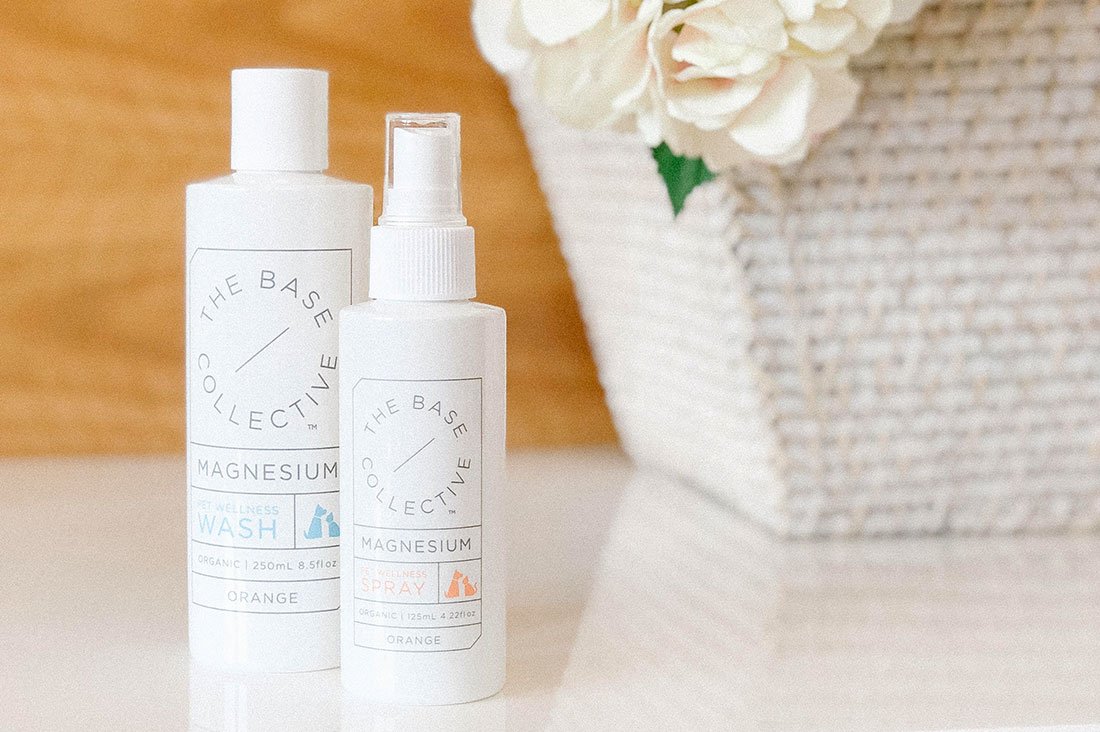 The Base Collective Magnesium Pet Wellness Wash and Spray bottles used as part of a magnesium for dogs health routine.